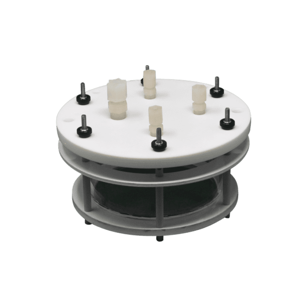 White circular lab equipment with screws.