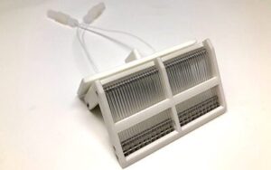 A white plastic holder with wires attached to it.