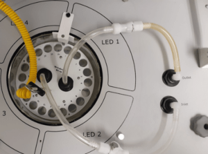 Machine panel with tubes and LED indicators.
